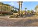 Beautiful multi-Gathering home entry with brick paved entry and sign amongst meticulously kept landscaping at 9144 Las Manaitas Ave # 201, Las Vegas, NV 89144