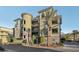A striking building featuring multiple floors, balconies, and manicured greenery along the sidewalk at 9144 Las Manaitas Ave # 201, Las Vegas, NV 89144