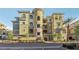 A beautiful condo building with multiple floors and balconies under a bright blue sky at 9144 Las Manaitas Ave # 201, Las Vegas, NV 89144