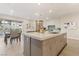 Open-concept kitchen with dining area in the background and a kitchen island with bar stool seating at 9144 Las Manaitas Ave # 201, Las Vegas, NV 89144