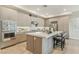 Sleek kitchen showcasing stainless steel appliances, light wood cabinets, and a spacious island with seating at 9144 Las Manaitas Ave # 201, Las Vegas, NV 89144