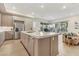 Spacious kitchen with a central island, stainless steel appliances, and seamless flow to the living spaces at 9144 Las Manaitas Ave # 201, Las Vegas, NV 89144