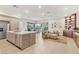 Open concept living space with island kitchen, dining area, and comfortable living room with built-ins at 9144 Las Manaitas Ave # 201, Las Vegas, NV 89144