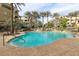 Resort-style swimming pool with waterfall feature, surrounded by palm trees and comfortable lounge chairs at 9144 Las Manaitas Ave # 201, Las Vegas, NV 89144