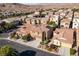 Aerial shot of a two-story home with tile roof, stone accents, two-car garage in a community at 9869 White Lilac St, Las Vegas, NV 89178