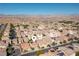 Expansive aerial view of a desert community showcasing well-maintained homes with mountain views in the background at 9869 White Lilac St, Las Vegas, NV 89178