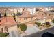Aerial view of a two-story home with a tile roof, stone accents, and a two car garage at 9869 White Lilac St, Las Vegas, NV 89178