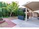 Backyard featuring concrete patio, red brick trim, bar island and mature foliage at 9869 White Lilac St, Las Vegas, NV 89178