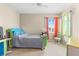Bright bedroom with carpet, large windows and colorful decor creates a playful atmosphere at 9869 White Lilac St, Las Vegas, NV 89178