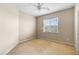 Bright, carpeted bedroom with a window, ceiling fan, and neutral walls offering a blank canvas for customization at 9869 White Lilac St, Las Vegas, NV 89178