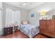 Cozy bedroom features a twin bed, wood floors, ceiling fan, and neutral color scheme for relaxation at 9869 White Lilac St, Las Vegas, NV 89178