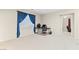 Bedroom with a work space next to the window and blue curtains at 9869 White Lilac St, Las Vegas, NV 89178