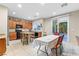 Open kitchen and dining area featuring granite countertops and sliding glass doors to backyard at 9869 White Lilac St, Las Vegas, NV 89178