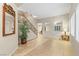 Spacious foyer featuring staircase with iron railing, tile floors, and natural lighting at 9869 White Lilac St, Las Vegas, NV 89178