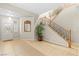 Inviting foyer with staircase, tile flooring, and decorative mirror enhancing natural light at 9869 White Lilac St, Las Vegas, NV 89178