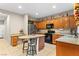 Well-equipped kitchen with granite counters, stainless steel appliances, and breakfast bar seating at 9869 White Lilac St, Las Vegas, NV 89178