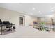 Bright living room featuring neutral walls, carpet flooring, and an elegant wrought iron banister with wood trim at 9869 White Lilac St, Las Vegas, NV 89178