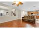 Open-concept living area showcases hardwood floors, stairs, and seamlessly integrates the kitchen at 9869 White Lilac St, Las Vegas, NV 89178