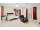 Cozy bedroom featuring a ceiling fan, and a comfy chair for relaxing at 9869 White Lilac St, Las Vegas, NV 89178