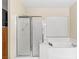 Bathroom featuring glass enclosed shower and soaking tub with window and blinds at 9869 White Lilac St, Las Vegas, NV 89178