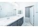 A modern bathroom with double sinks, granite counters, and sleek fixtures at 1005 Warsaw Ave, Henderson, NV 89015