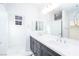 Bright bathroom featuring double sink vanity and a large mirror at 1005 Warsaw Ave, Henderson, NV 89015