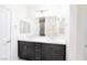 Bright bathroom featuring double sink vanity and a large mirror at 1005 Warsaw Ave, Henderson, NV 89015