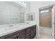 Bright bathroom featuring a double vanity, quartz countertop, and a large mirror at 1005 Warsaw Ave, Henderson, NV 89015