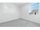 Bright bedroom with plush carpeting, neutral walls, and a large window with mountain views at 1005 Warsaw Ave, Henderson, NV 89015
