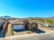 Charming single-story home with a neutral-colored exterior, desert landscaping, and mountain views at 1005 Warsaw Ave, Henderson, NV 89015