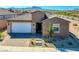 Charming single-story home featuring a two-car garage, desert landscaping and a mountain view at 1005 Warsaw Ave, Henderson, NV 89015