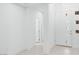 Bright hallway with an interior door featuring white trim, tile flooring, and a paneled front door at 1005 Warsaw Ave, Henderson, NV 89015