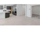 Bright kitchen with wood cabinets and stainless steel appliances with a view to carpeted bedroom at 1005 Warsaw Ave, Henderson, NV 89015