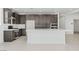 Spacious kitchen features stainless steel appliances, dark wood cabinets, and a large center island at 1005 Warsaw Ave, Henderson, NV 89015