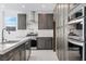 Modern kitchen with stainless steel appliances, dark wood cabinets, and white countertop space at 1005 Warsaw Ave, Henderson, NV 89015