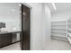 Walk-in pantry with plentiful shelving located near the kitchen and a stylish sliding barn door at 1005 Warsaw Ave, Henderson, NV 89015