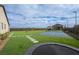 Spacious backyard with artificial turf, a trampoline and a view of the tennis court at 10420 Luella Ct, Las Vegas, NV 89143