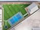 Aerial view of a backyard with a green lawn, playground, and a blue sports court at 10420 Luella Ct, Las Vegas, NV 89143
