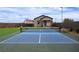 Backyard featuring a basketball hoop, tennis court, artificial turf, and beautiful landscaping at 10420 Luella Ct, Las Vegas, NV 89143