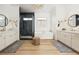 Bright and airy bathroom showcasing dual vanities, modern fixtures, and a sleek glass-enclosed shower at 10420 Luella Ct, Las Vegas, NV 89143