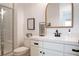 Modern bathroom featuring a walk-in shower and a white vanity with quartz countertops and dark hardware at 10420 Luella Ct, Las Vegas, NV 89143
