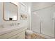 Bright bathroom featuring a glass-enclosed shower, wood-style floors, and elegant white quartz countertops at 10420 Luella Ct, Las Vegas, NV 89143