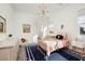 Bright bedroom with a white metal bed frame and a blue rug with white trim details at 10420 Luella Ct, Las Vegas, NV 89143