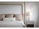 Inviting bedroom featuring a four-poster bed, plush pillows, and a serene, minimalist design at 10420 Luella Ct, Las Vegas, NV 89143