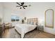 Well lit bedroom featuring a queen sized bed, ceiling fan, an area rug, and matching night stands at 10420 Luella Ct, Las Vegas, NV 89143