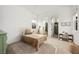 Bright bedroom with neutral colors, carpeted floors, and a small bathroom attached at 10420 Luella Ct, Las Vegas, NV 89143