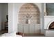Close up of designer built-in archway featuring storage and geometric wallpaper at 10420 Luella Ct, Las Vegas, NV 89143