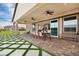 Spacious covered patio area with ceiling fans, outdoor furniture and view of the backyard at 10420 Luella Ct, Las Vegas, NV 89143