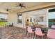 Inviting outdoor covered patio featuring ceiling fans, patio furniture and view to the kitchen and dining room at 10420 Luella Ct, Las Vegas, NV 89143