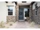 Charming front entrance enhanced by stone accents and a comfortable seating area at 10420 Luella Ct, Las Vegas, NV 89143